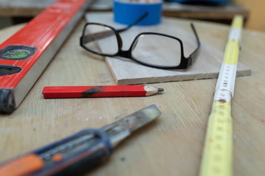 On the table lies a few measuring tools necessary for any construction work at home or on the construction site.