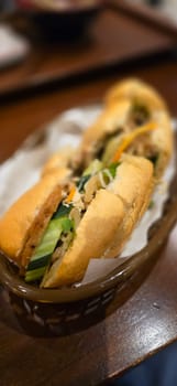 Sandwich Banh mi, vietnamese baguette with grilled chicken and mixed salad, vietnamese sandwich in local asian restaurant