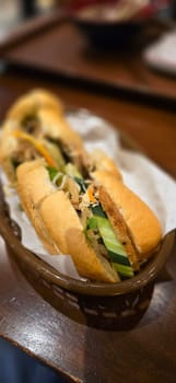 Sandwich Banh mi, vietnamese baguette with grilled chicken and mixed salad, vietnamese sandwich in local asian restaurant