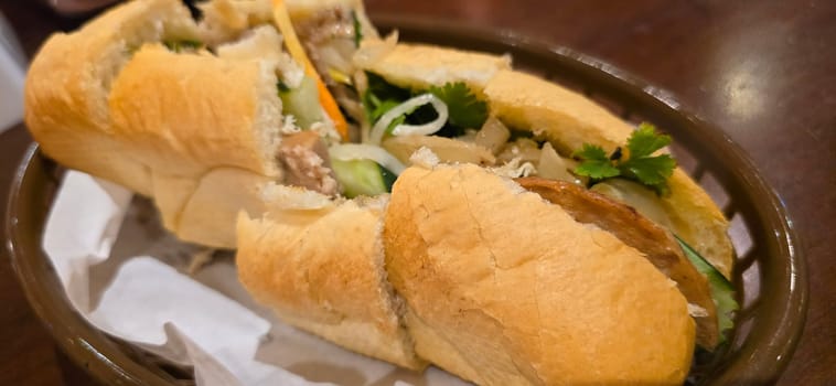 Sandwich Banh mi, vietnamese baguette with grilled chicken and mixed salad, vietnamese sandwich in local asian restaurant