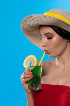 A teenager sipping a cold alcoholic drink through a straw during a hot summer.
