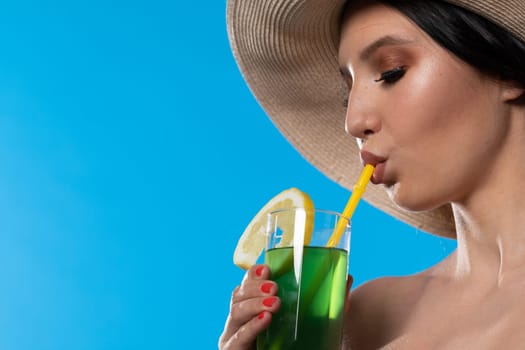 A teenager sipping a cold alcoholic drink through a straw during a hot summer.