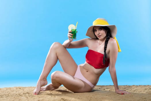 During hot summer, the teenager with a hat on her head holds an alcoholic drink in her hand.