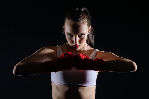 Show of strength before the start of the fight. Hands joined together with five hands together. Clenched fists of a female athlete.
