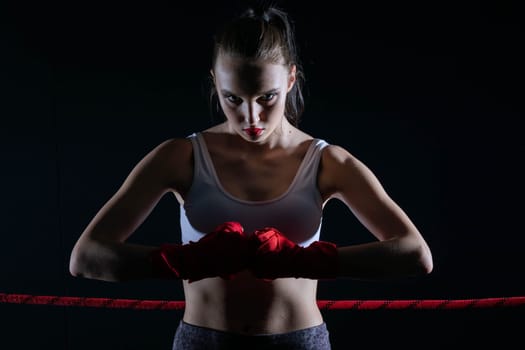 Show of strength before the start of the fight. Hands joined together with five hands together. Clenched fists of a female athlete.