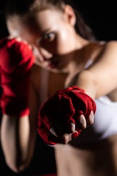 A strong punch with the fist straight ahead to the target. The athlete focused during training just before entering the ring boards.