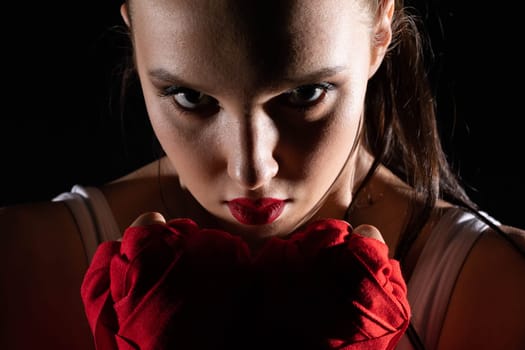 The head is hidden behind the strong guard of a professional sportswoman. A strong and athletic woman in the ring of sports.