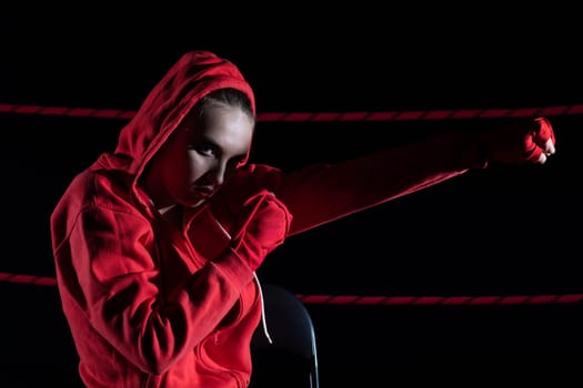 A strong punch with the fist straight ahead to the target. The athlete focused during training just before entering the ring boards.
