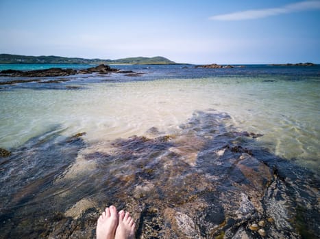 Bare feet at Carrickfad by Portnoo at Narin Strand in County Donegal Ireland.