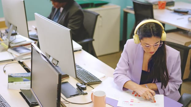 Concentrated woman working in paperwork in a modern coworking