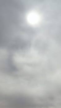 Blue gray light sky nature white clouds whether background, sun face . High quality photo
