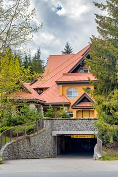 Garage entrance of luxurious residential building with big roof on spring season in Canada