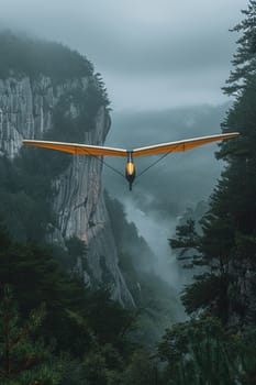 Hang glider soaring above the mountains, representing freedom and the thrill of flight.