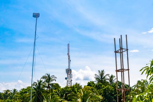 Red white 5G tower with blue sky background radiation kills us in Zicatela Puerto Escondido Oaxaca Mexico.