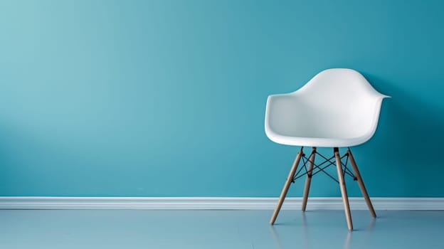 A white chair against a blue wall with wood legs