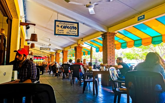 The famous restaurant and cafe El Cafecito with people building and inside in Zicatela Puerto Escondido Oaxaca Mexico.