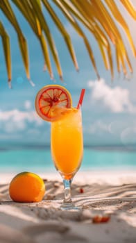 A close up of a drink sitting on the beach with an orange