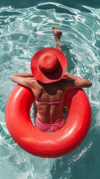 A woman in a red hat floating on an inflatable ring