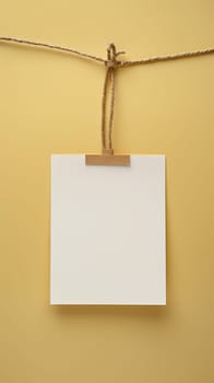 A picture of a piece of paper is tied to rope