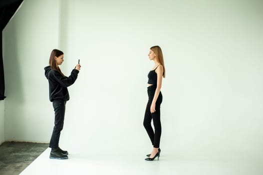 Model test portrait with young beautiful fashion model posing on background.