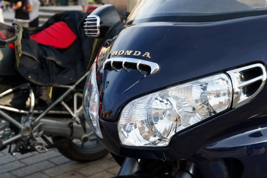 Warsaw, Poland - August 6, 2023: Close-up of the headlights and fairing of a Honda Gold Wing 1800 motorcycle