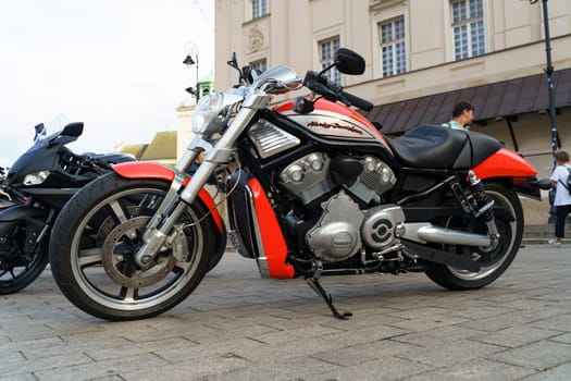 Warsaw, Poland - August 6, 2023: A Harley Davidson motorcycle is parked in a parking lot, side view.