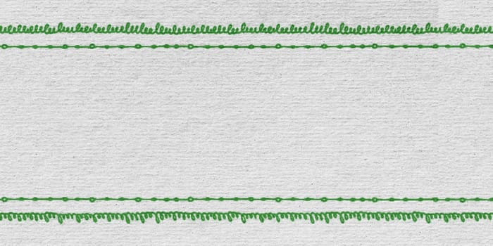 A close-up view of a piece of paper with evenly spaced green lines running vertically. The lines create a grid pattern across the paper, enhancing its organization and structure.