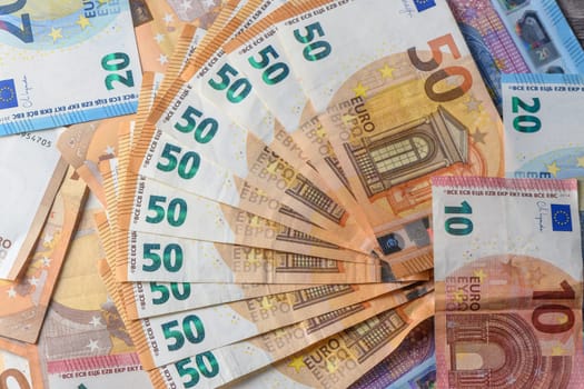 Fifty euro banknotes, arranged in a fan, against money background 6