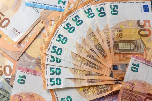 Fifty euro banknotes, arranged in a fan, against money background 8