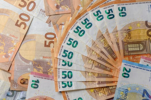 Euro 50 banknotes fanned out on a background of paper bills 6