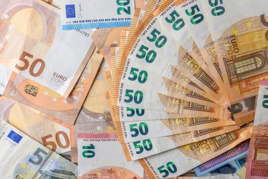 Euro 50 banknotes fanned out on a background of paper bills 5