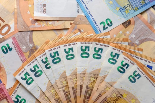 Euro 50 banknotes fanned out on a background of paper bills 4