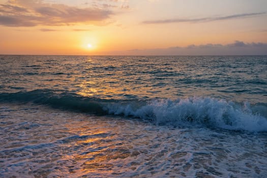 The picturesque sea at sunset. Sunset on the Black Sea with the sun, Abkhazia. Colorful sunset with waves.