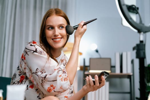 Woman influencer shoot live streaming vlog video review makeup utmost social media or blog. Happy young girl with cosmetics studio lighting for marketing recording session broadcasting online.