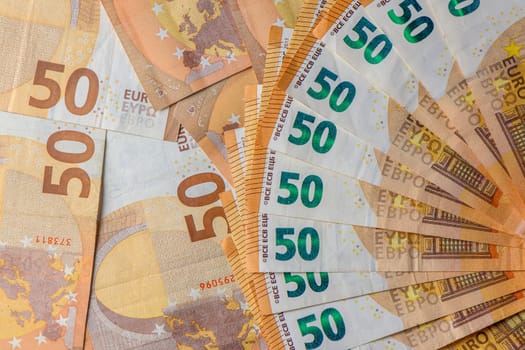 Euro 50 banknotes fanned out on a background of paper bills 8