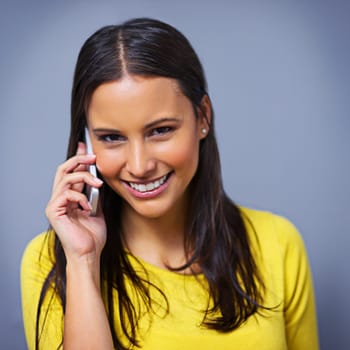 Woman, phone call and contact in studio with portrait for conversation, talk and listen by blue background. Girl, person and model on smartphone, smile or communication with mobile network in Mexico.
