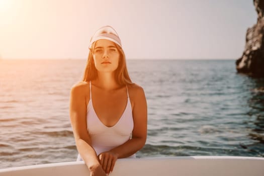 Close up shot of happy young caucasian woman looking at camera and smiling. Cute woman portrait in bikini posing on a volcanic rock high above the sea