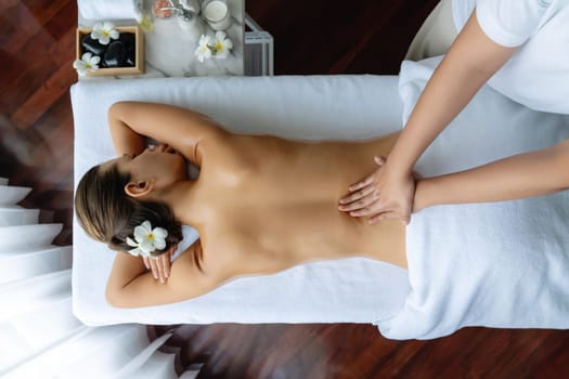 Panorama top view woman customer enjoying relaxing anti-stress spa massage and pampering with beauty skin recreation leisure in day light ambient salon spa at luxury resort or hotel. Quiescent