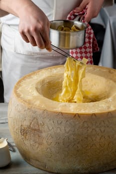 Fresh pasta with sauce in a whole parmesan wheel