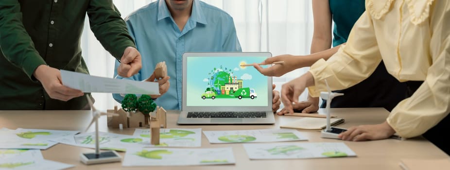 Green city and waste management illustrate displayed on laptop. Business team presenting green design to customer. ESG environment social governance and Eco conservative concept. Closeup. Delineation.