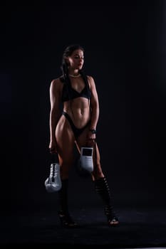 Sport fitness female in a white boxing gloves, studio shot