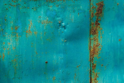 turquoise painted beaten steel surface with stains of rust - full-frame background and texture.