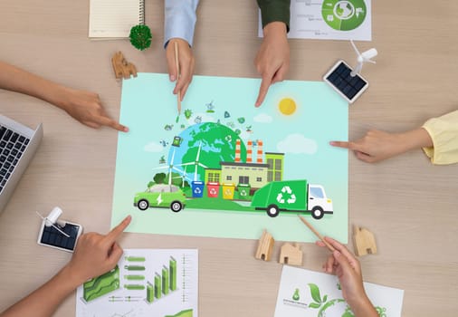 Green city and waste management poster was placed on meeting table during a green business meeting discussion. ESG environment social governance and Eco conservative concept. Top view. Delineation.