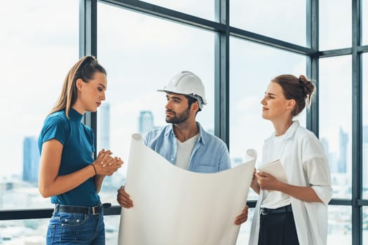 Group of architect engineer looking at project plan while brainstorming idea about building structure. Manager team discuss about building construction while standing near with city view. Tracery.