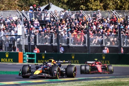 MELBOURNE, AUSTRALIA - MARCH 24: Max Verstappen of the Netherlands drives the Oracle Red Bull Racing RB20 and leads Carlos Sainz of Spain and Scuderia Ferrari at the 2024 Australian Grand Prix at Albert Park in Melbourne, Australia