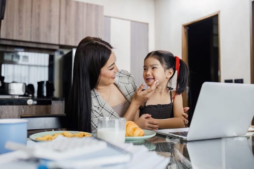business woman work from home and take care of her child while working.