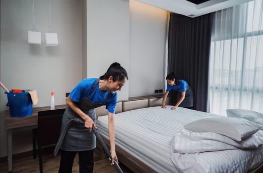 cleaning service woman worker clean bedroom at home. housekeeper cleaner feel happy and make bed look neat. housework and housekeeping cleaning service.