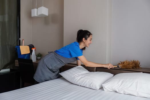 cleaning service woman worker clean bedroom at home. housekeeper cleaner feel happy and make bed look neat. housework and housekeeping cleaning service.