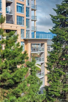 High-rise residential building with big patio on bright day in Vancouver, Canada.