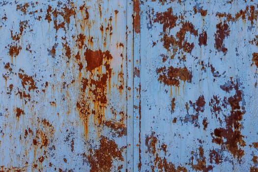 faded blue paint on flat sheet steel surface with stains of rust - full-frame background and texture.